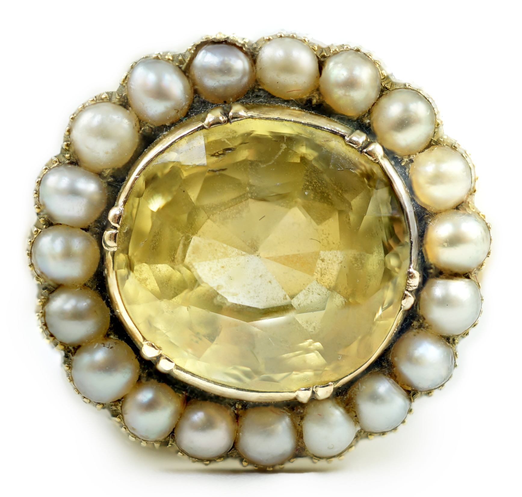 A 19th century style gold and round cut single stone yellow sapphire set dress ring, with split pearl set border